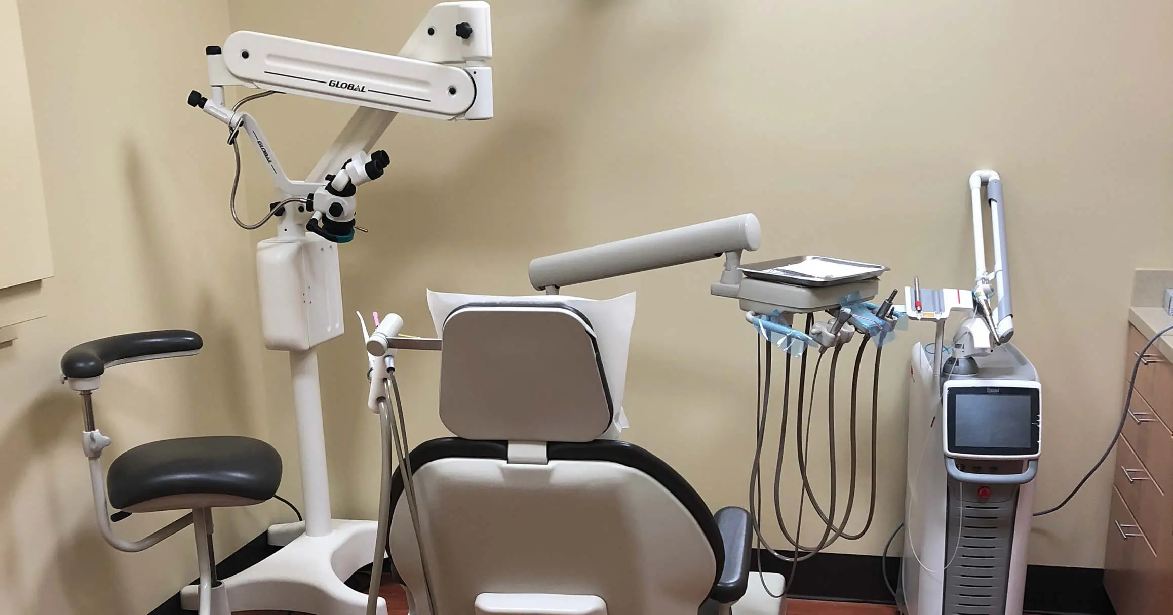 A treatment room at Charlottesville Dental Care, with the chair, overhead light and chairside monitor