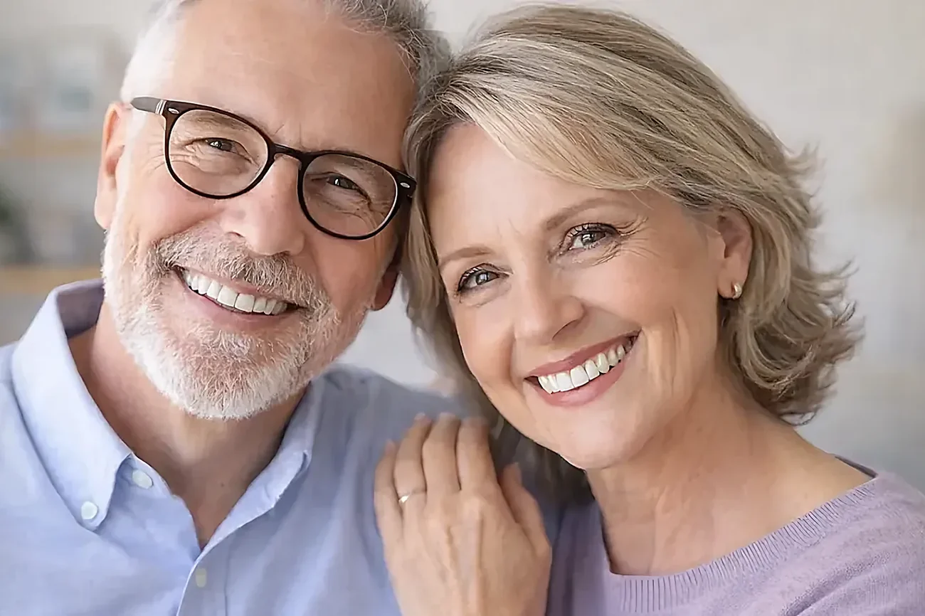 An older couple smiling together at home