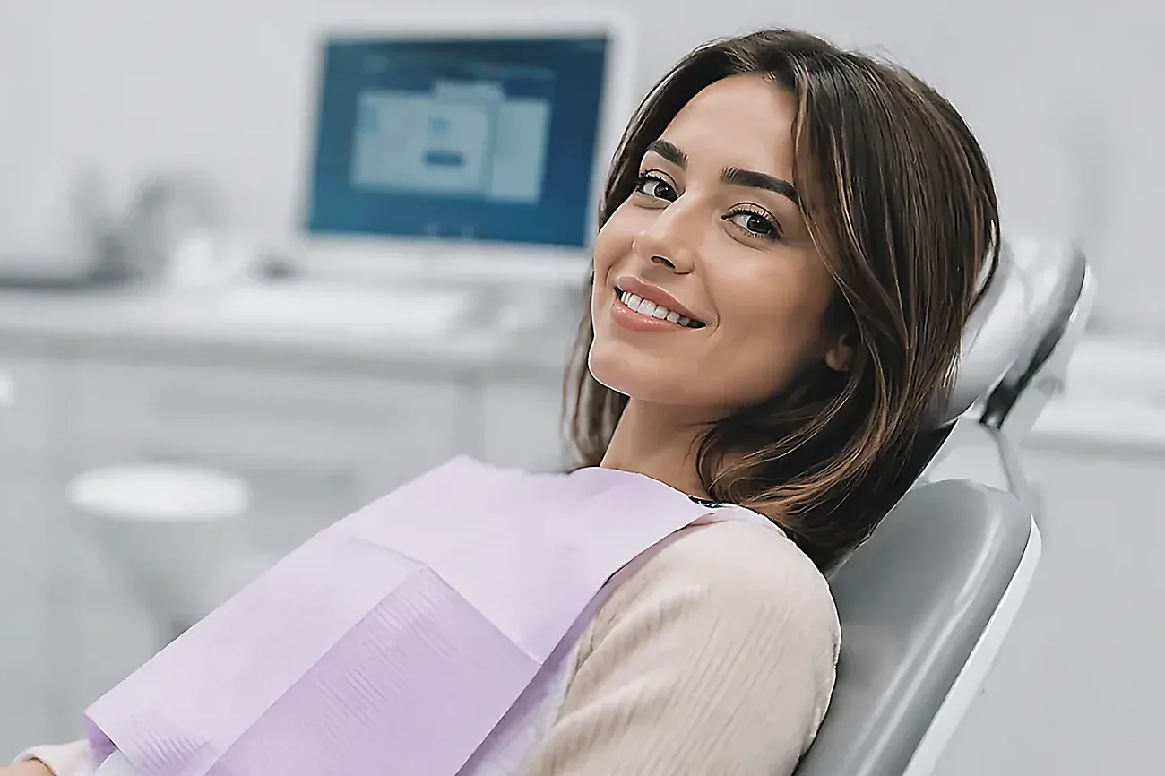 A patient smiling in the dental chair