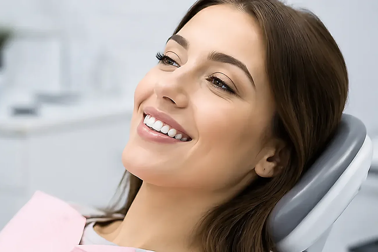 A patient smiling in the dental chair