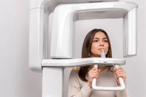 A patient positioned in a dental imaging scanner