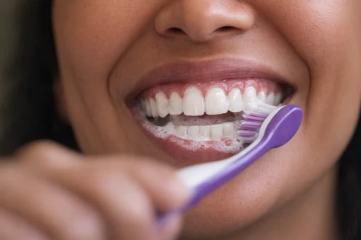 A woman brushing her teeth